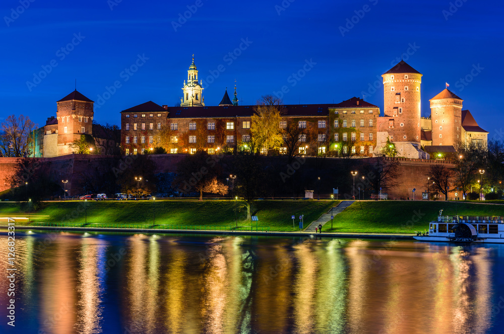 A night view of Wawel castle located on bank of Vistula river in Krakow city, Poland.