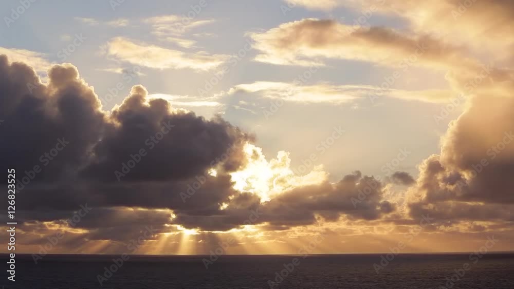 WS Sun breaking through clouds over ocean