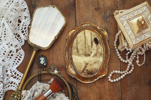 vintage woman toilet fashion objects next to photo frame