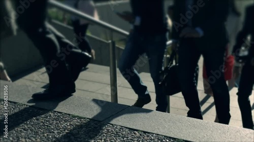Businessmen crowd on the way to work in the morning. Concept for finance, business, job and economy. Modern buildings in business district. Action by day. Focus blur. Toned