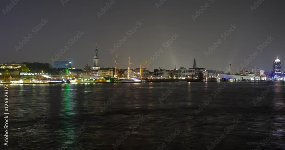 Hamburg, Germany - view over river Elbe from south shore to illuminated skyline with museum-ship Rickmer Rickmers and main church St. Michaelis / Michel at night - Timelapse with zoom out - April 2016 Hamburg, Germany - view over river Elbe from south shore to illuminated skyline with museum-ship Rickmer Rickmers and main church St. Michaelis / Michel at night - Timelapse with zoom out - April 2016