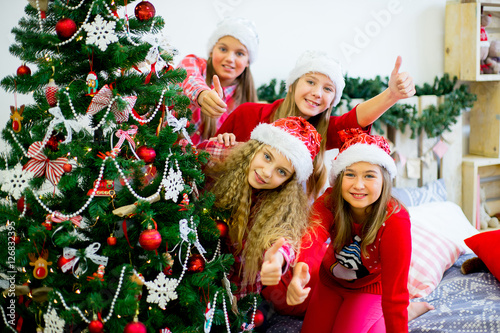 Girls decorate the Christmas tree