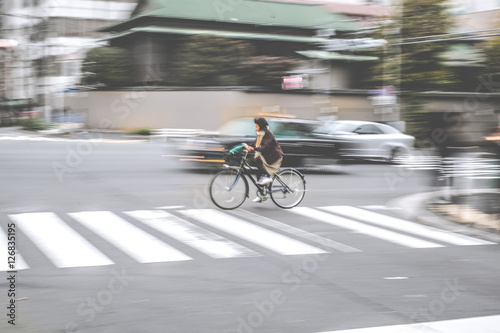motion blur of woman cycling the bicycle with vintage tone