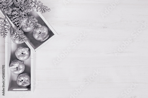 Christmas decor of silver apples in boxes on wooden white background. Top view. Xmas background.