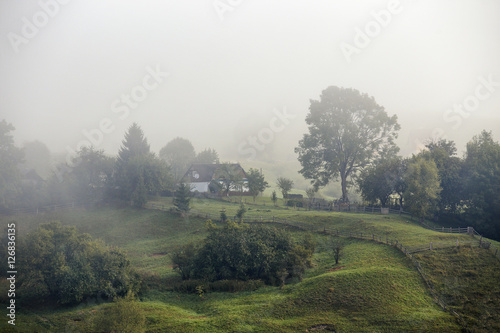 Foggy morning in a village on the hills