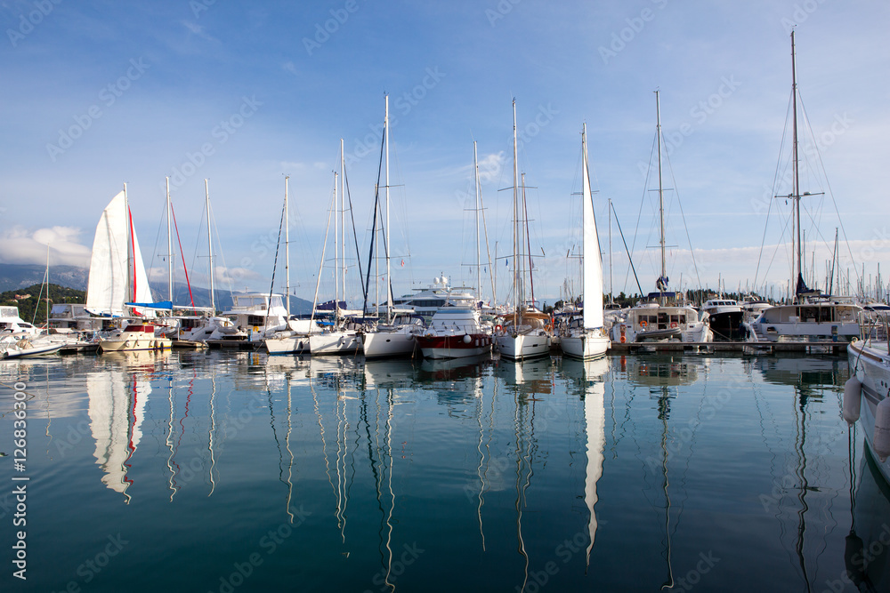 yachts at marina in Greece, reflected in the water
