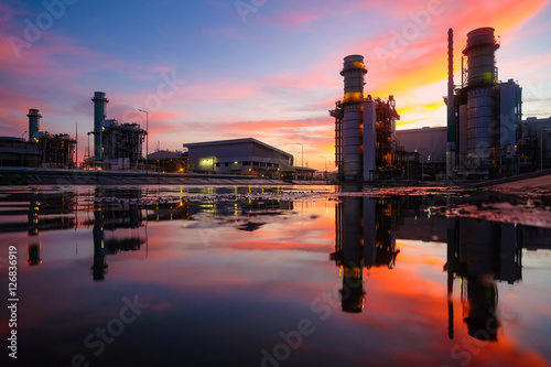 Combine cycle power plant with reflection on reservoir pond against twilight sky