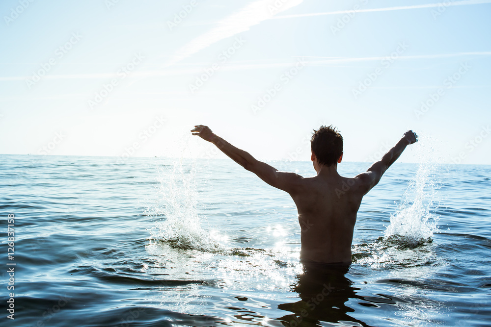 Fototapeta premium Male jumping in the sea