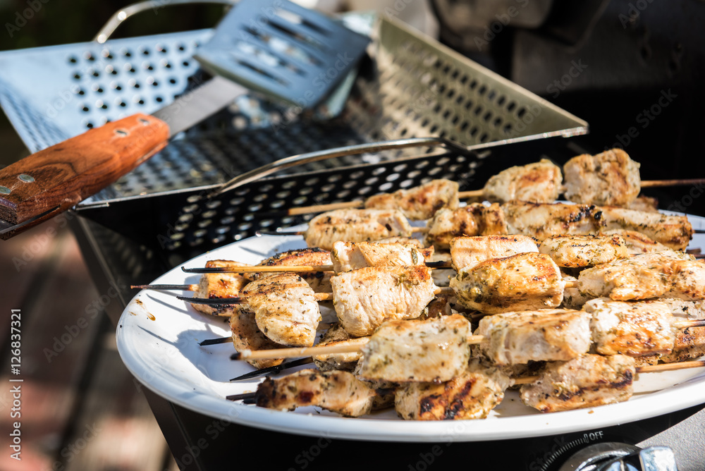 Chicken skewers on a white plate after grilling (Souvlaki)