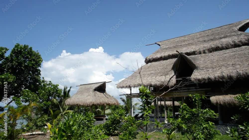 WS PAN Thatched villas surrounded by trees / Indonesia WS PAN Thatched villas surrounded by trees / Indonesia