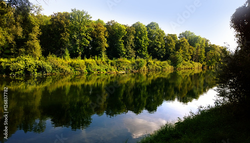 Summer in Bavaria, Isar river with calm waters and sky reflection
