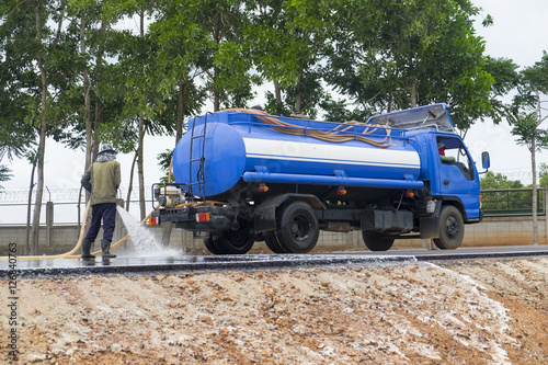 Water cleaning at the road with water truck