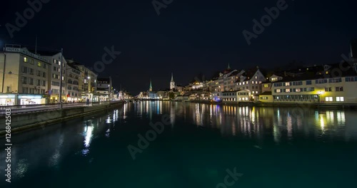 Wallpaper Mural Zurich, Switzerland - view from Rudolf-Brun-Bridge of river Limmat over downtown Zurich with colorful reflections on the water at night - Timelapse without motion Torontodigital.ca