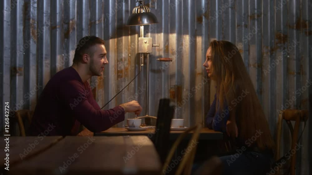 Couple having a coffee in a modern cafe. 4K UHD RAW edited footage Couple having a coffee in a modern cafe. 4K UHD RAW edited footage