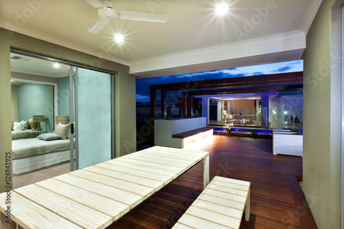 Interior lighting of a modern house with patio area at night