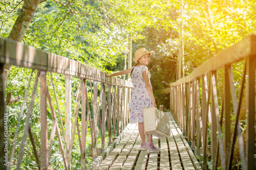 asian girl on the old bridge in the forest