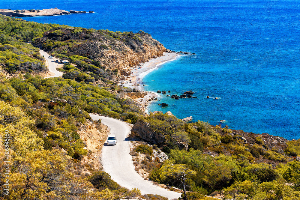 top view of lagoon  island  Rhodes, with a winding road and the car on it