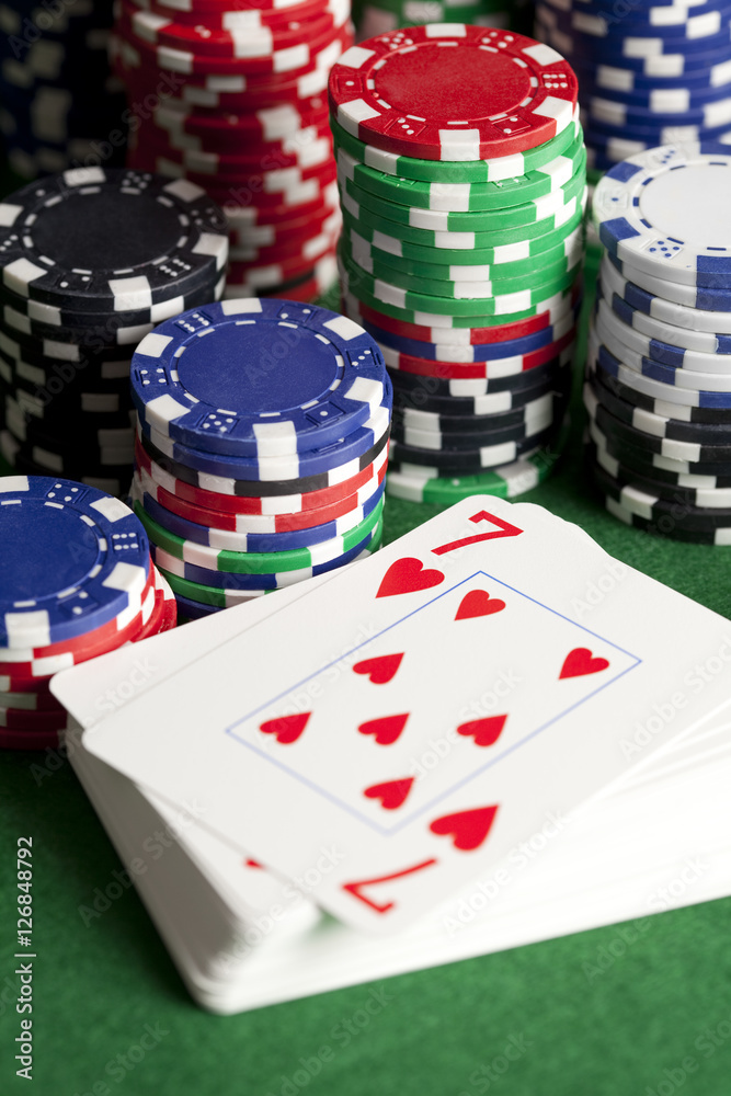 Playing cards and poker chips on green table Playing cards and poker chips on green table