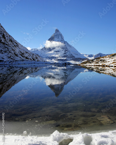 Matterhorn reflection on Riffelsee Lake in the early winter, Switzerland