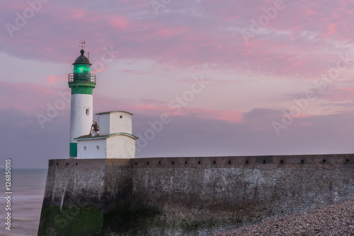 Lighthouse Le Treport under pink sky photo