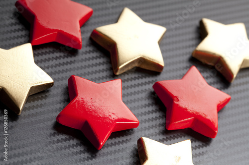 Red and gold stars on carbon background