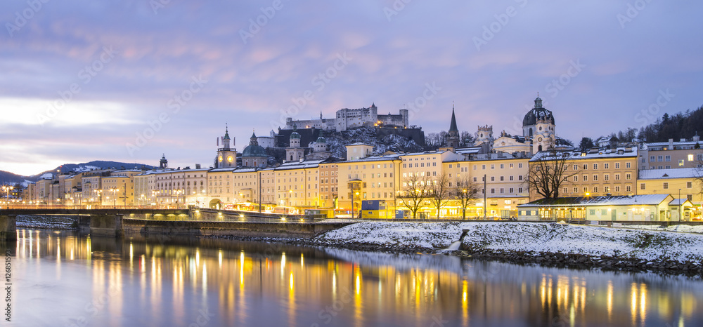 reflections in water of golden lights in European city in winter day
