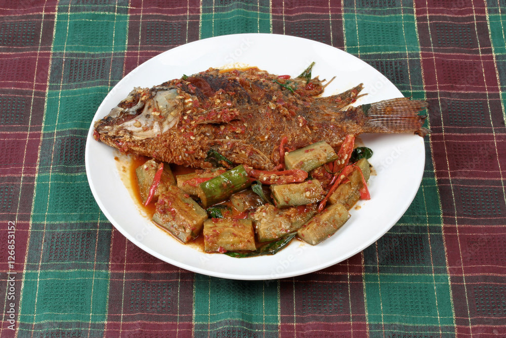 Deep-fried tilapia fish topped Spicy fried eggplant.