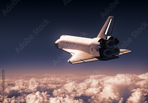 Fototapeta Naklejka Na Ścianę i Meble -  Space Shuttle Over Red Clouds