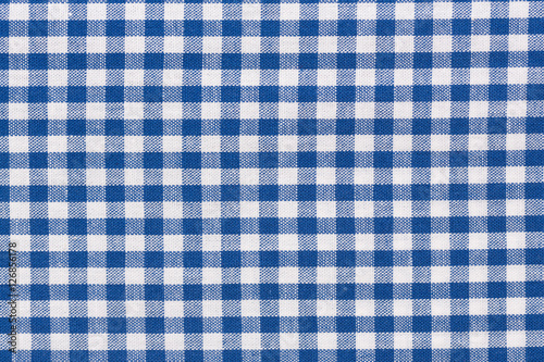 Blue checkered rural tablecloth background. photo