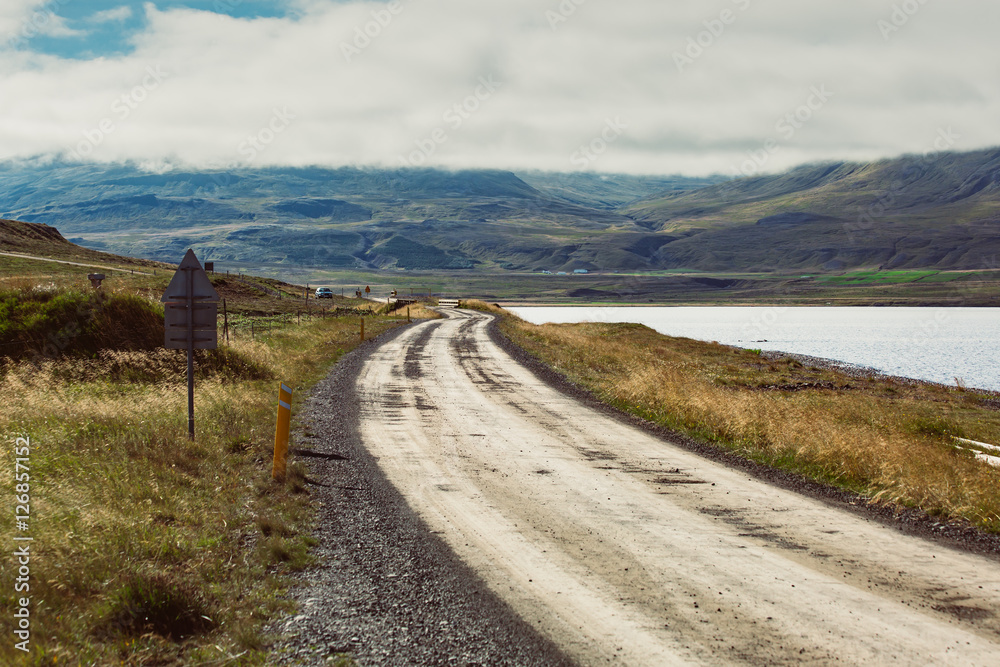 Icelandic landscape with a street and a lake Icelandic landscape with a street and a lake
