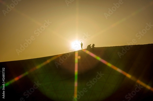 Silhouette of people on the top of sand dunes, Gobi desert, China
