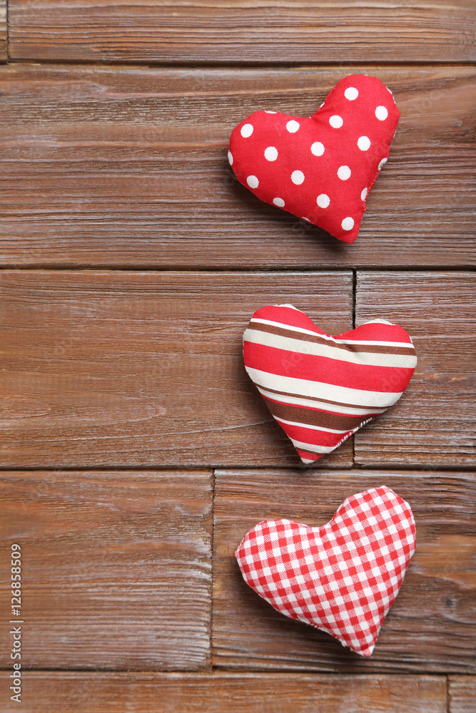 Love hearts on a brown wooden table Love hearts on a brown wooden table
