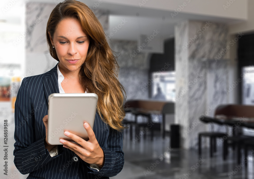Young woman using a tablet in her office Young woman using a tablet in her office