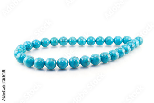 Turquoise necklace on white background