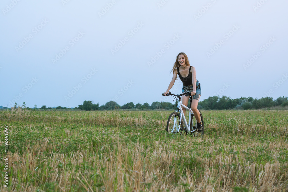 Woman riding on bicycle in the field Woman riding on bicycle in the field