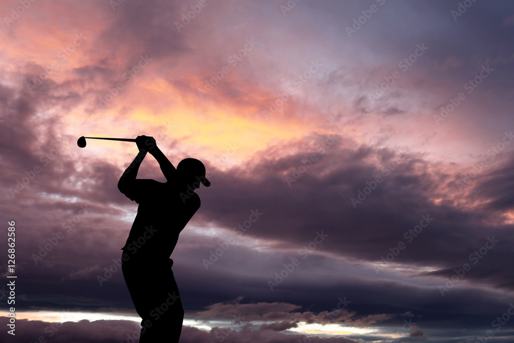 Golfer playing golf during sunset at competition event