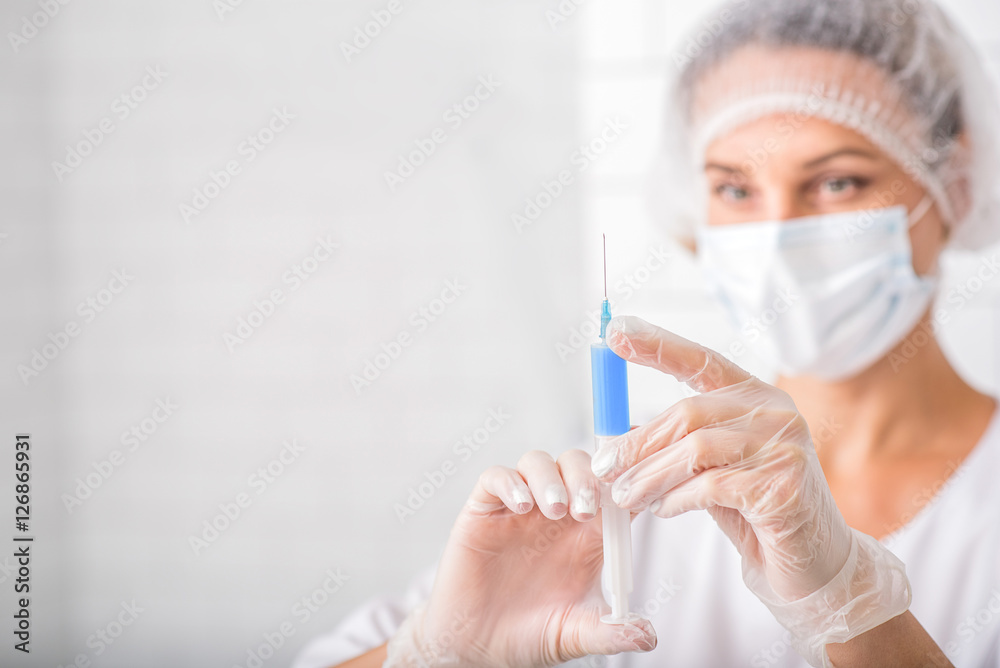 Skillful general practitioner preparing blood in syringe Skillful general practitioner preparing blood in syringe
