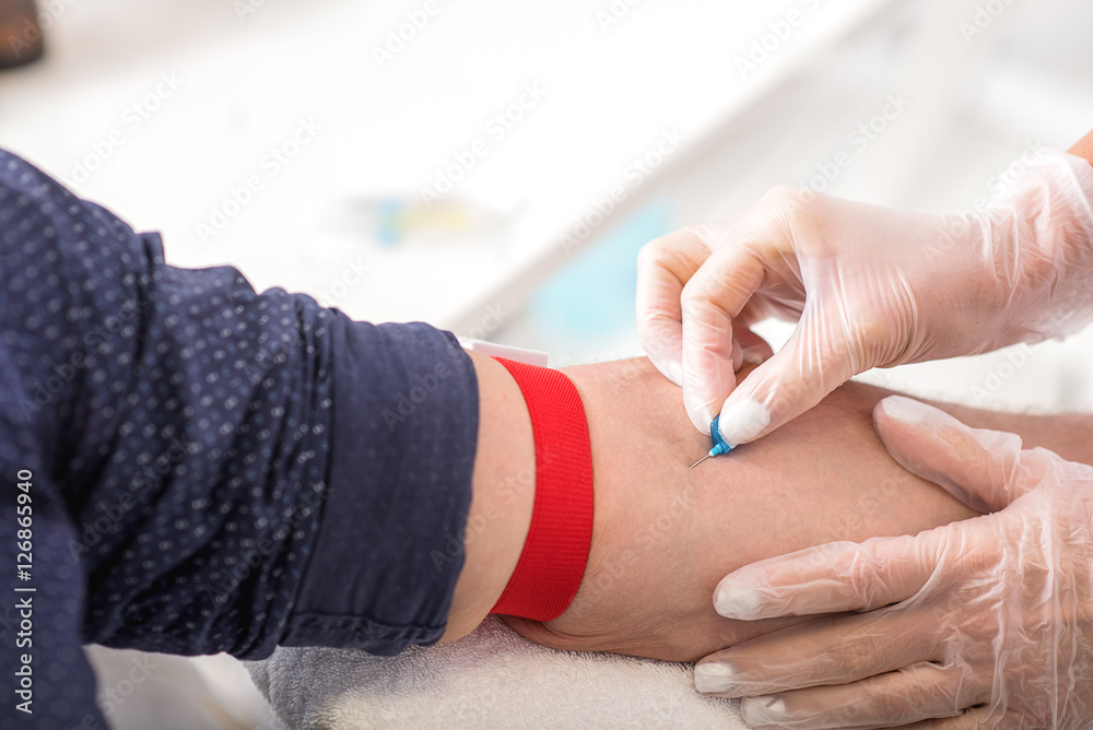 Professional general practitioner undergoing blood test