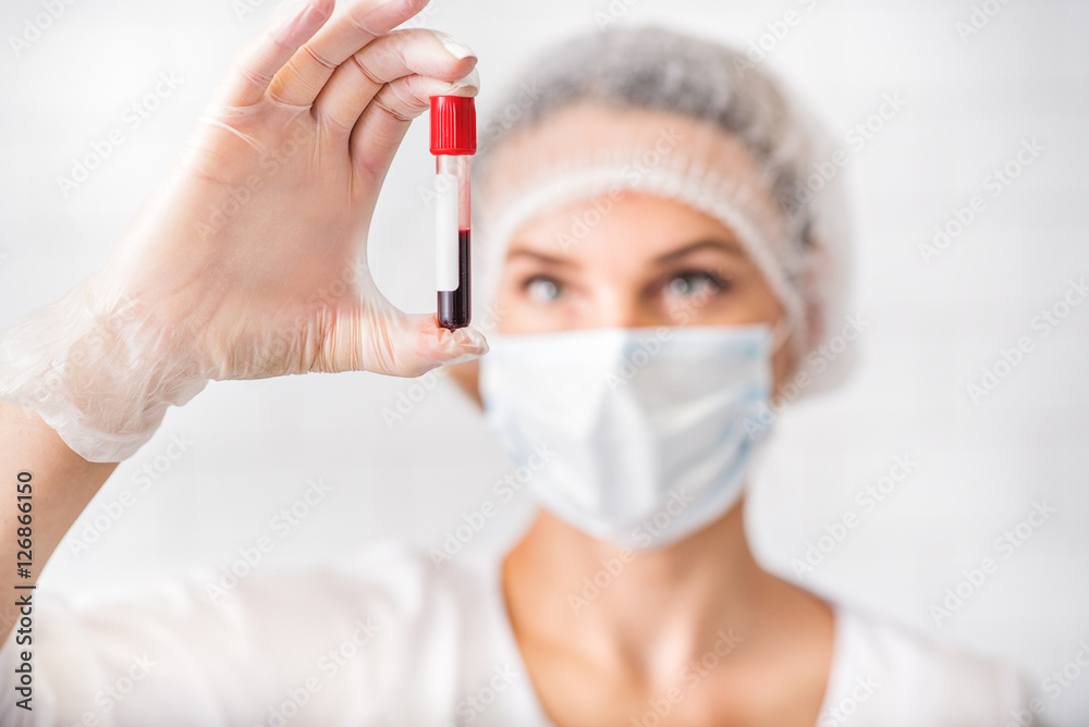 Professional general practitioner analyzing human blood