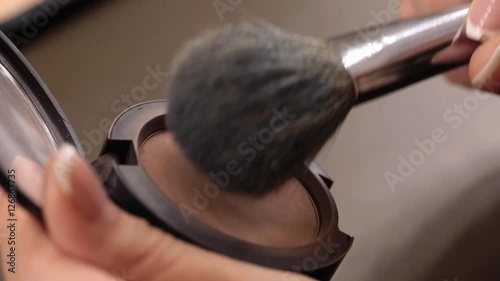 Close up of makeup brush moving over eye shadows