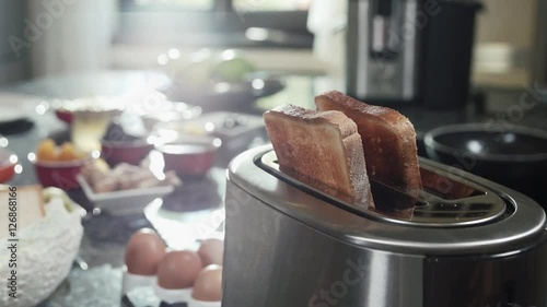 Roasted toast bread popping up from toaster slow motion