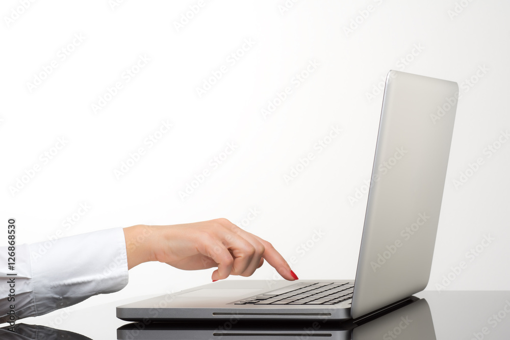 Closeup of business woman hand typing on laptop keyboard Closeup of business woman hand typing on laptop keyboard