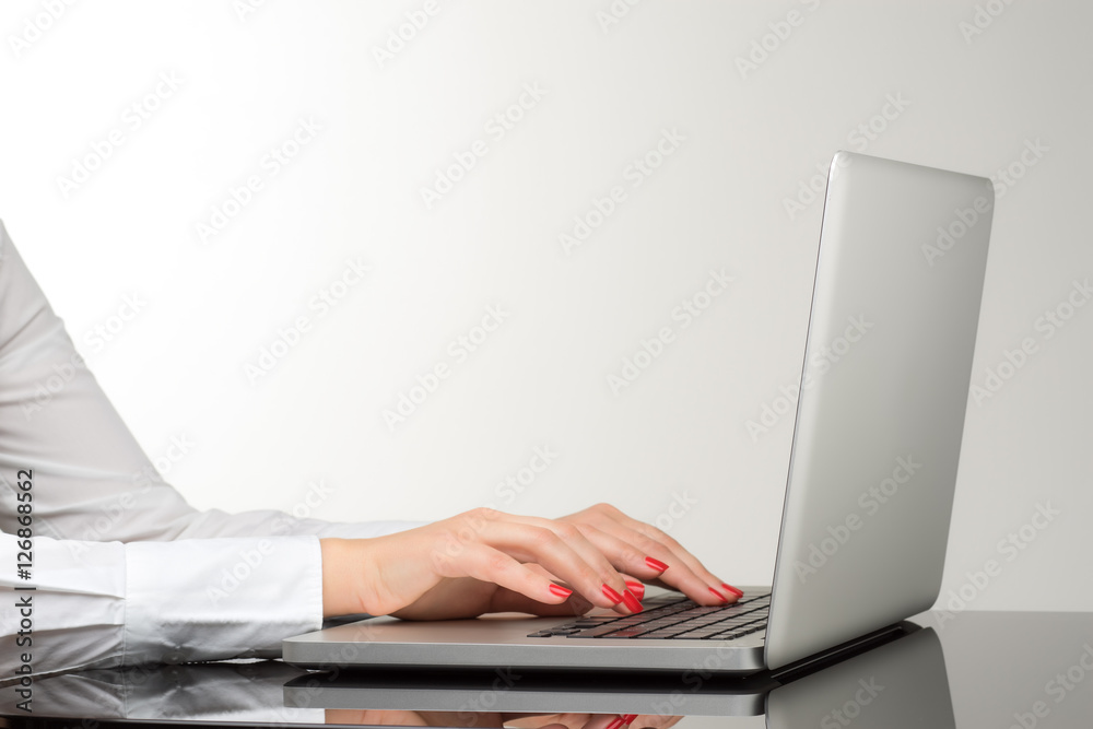 Closeup of business woman hand typing on laptop keyboard Closeup of business woman hand typing on laptop keyboard