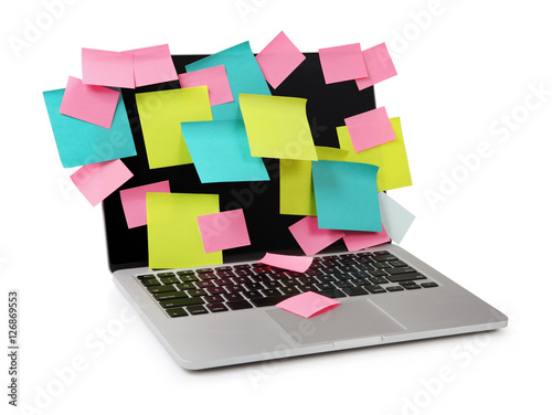 Image of laptop full of colorful sticky notes reminders on scree