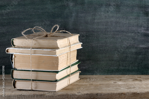 Pile of old books on wooden table