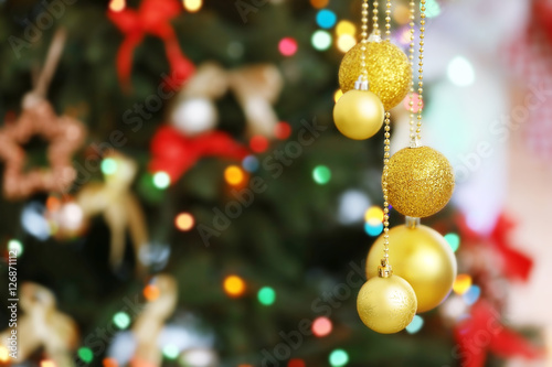 Beautiful balls on blurred Christmas tree background, closeup © Africa Studio