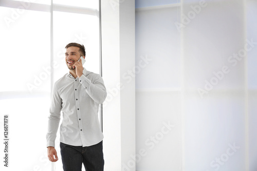 Young businessman with phon...