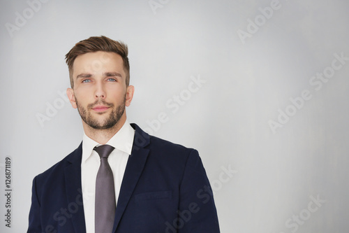 Young businessman on light background © Africa Studio