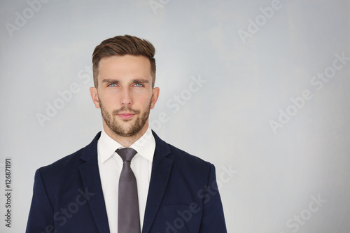 Young businessman on light ...