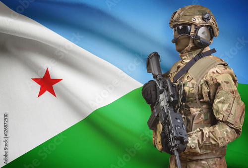 Soldier in helmet holding machine gun with flag on background series - Djibouti
